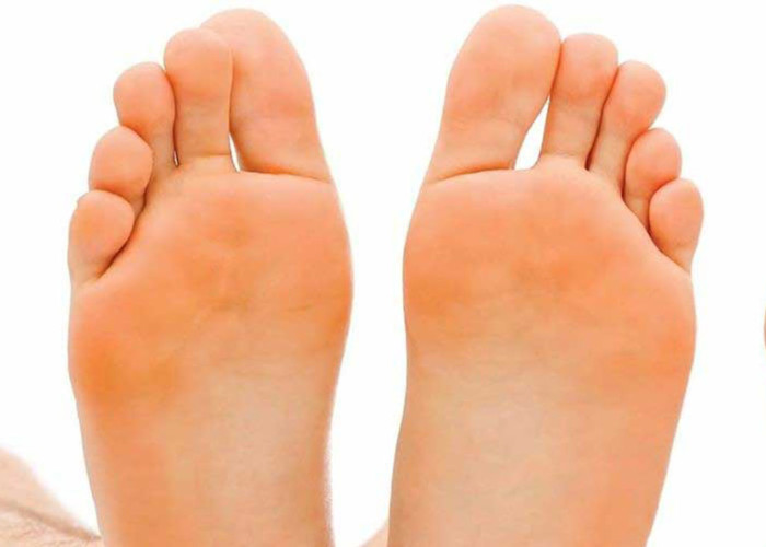 The soles of a womans feet pointing upwards